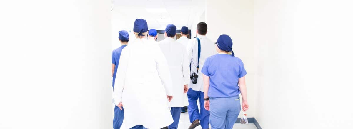 group of doctors walking on hospital hallway