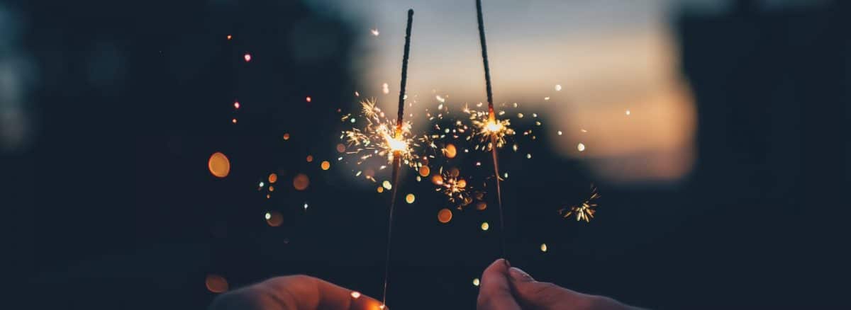 person holding fire cracker shallow focus photography