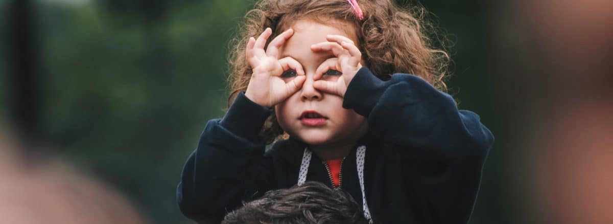 girl making hand gesture on her face