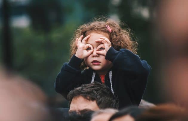 girl making hand gesture on her face