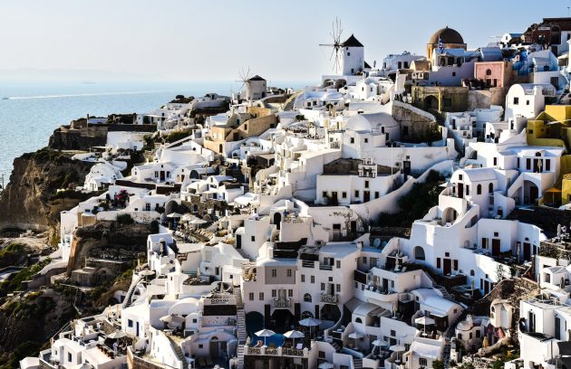 a view of a village on a cliff overlooking the ocean