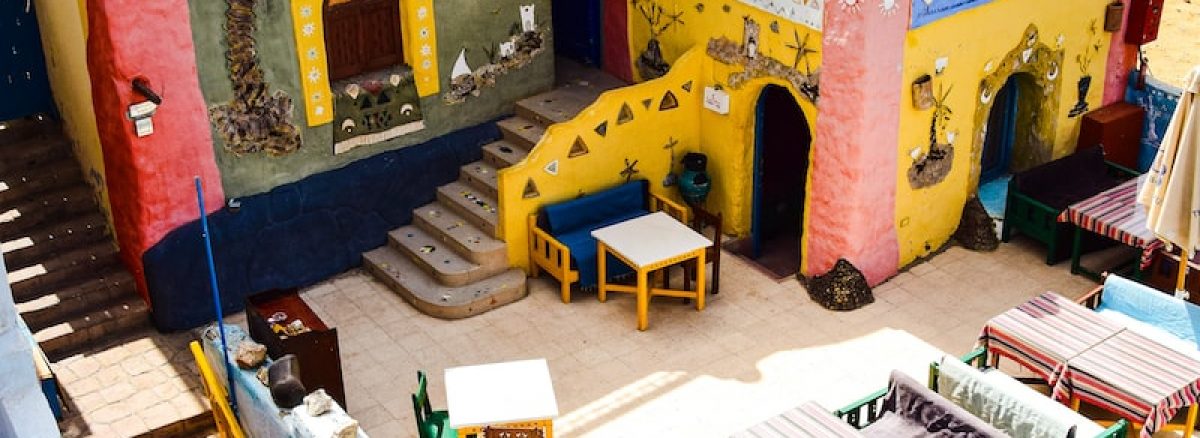 a colorfully painted building with stairs leading up to it