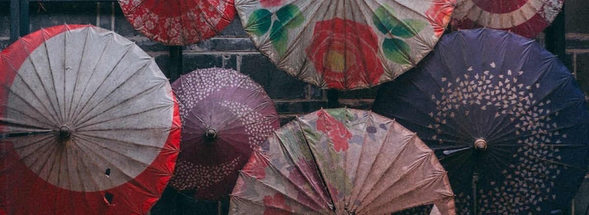 a bunch of umbrellas that are on a rack