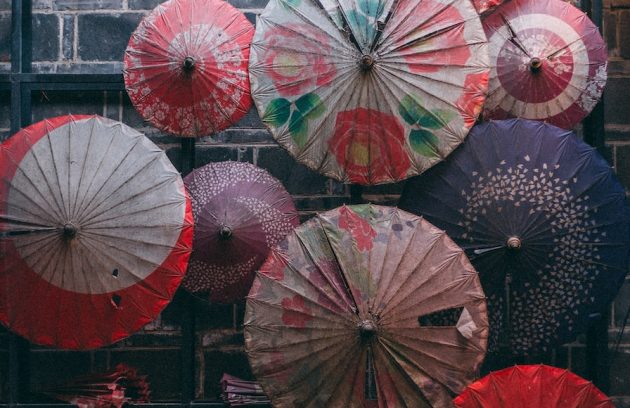 a bunch of umbrellas that are on a rack