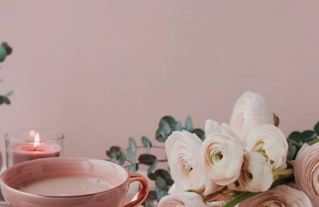 a cup of coffee and some cookies on a table