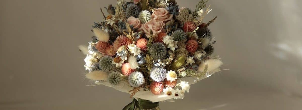 a bouquet of flowers sitting on top of a white table