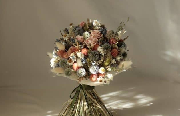 a bouquet of flowers sitting on top of a white table