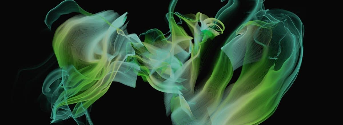 a green and white smoke swirls in the air