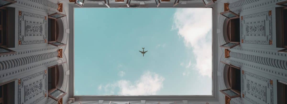 an airplane flying in the sky through a window