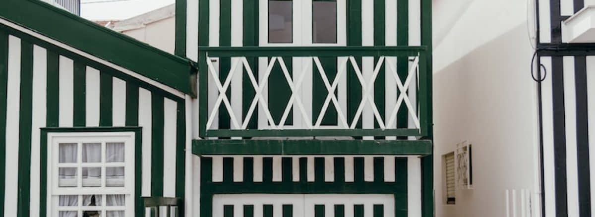 a bike parked in front of a green and white building