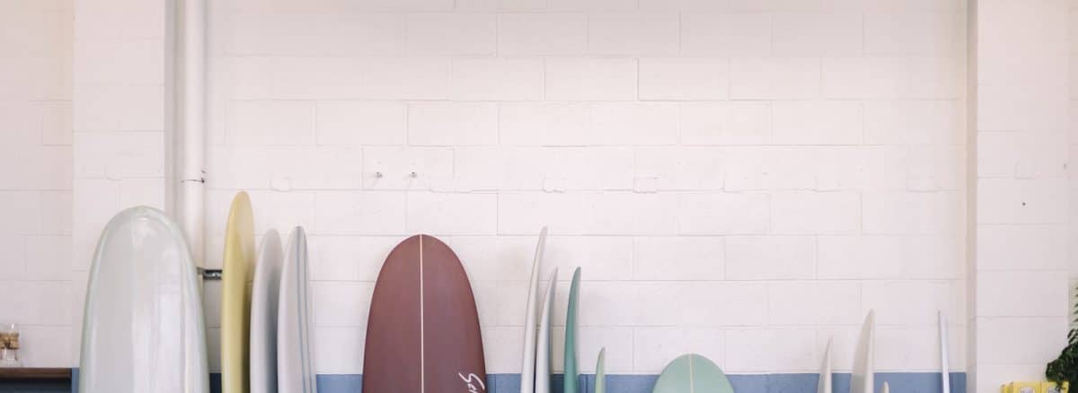 a group of surfboards lined up against a wall