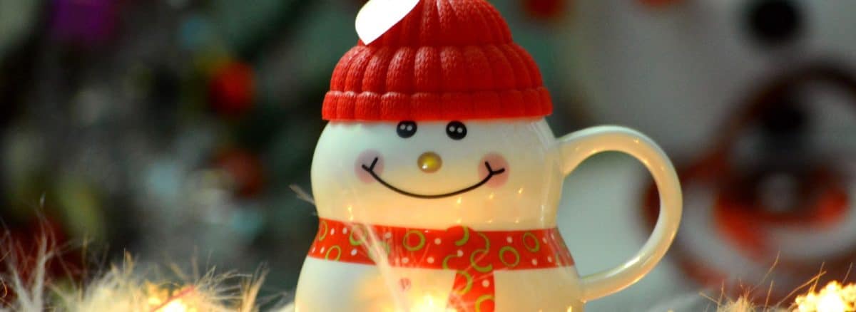 a snowman figurine with a red hat and scarf