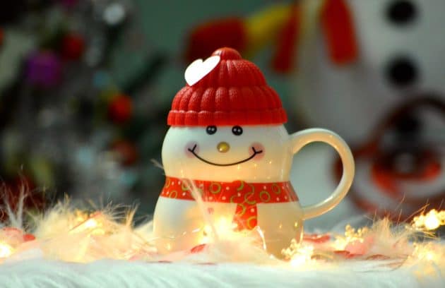a snowman figurine with a red hat and scarf