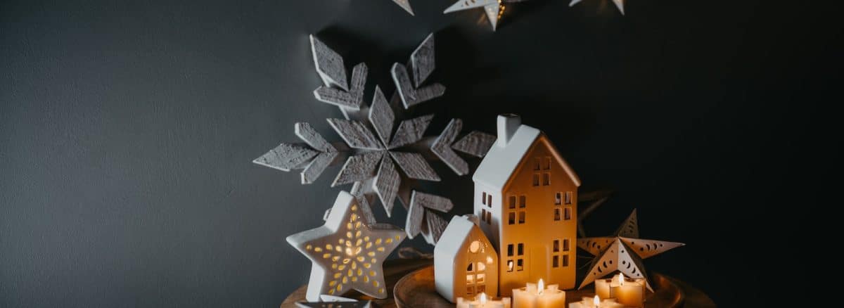 a wooden table topped with a snowflake and candles