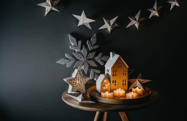 a wooden table topped with a snowflake and candles