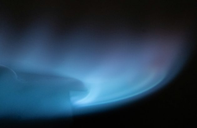 a blurry image of a blue flame on a black background